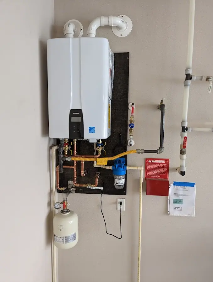 Professional plumber installing copper piping in a Rantoul home